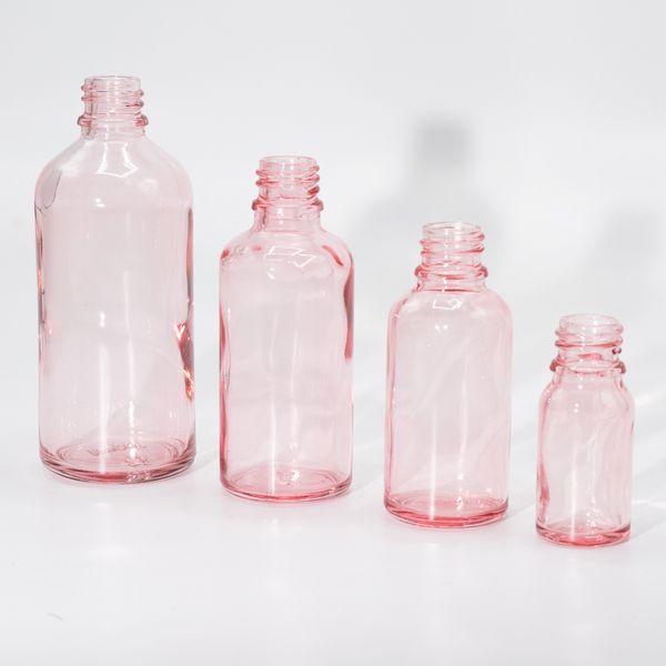 Rosa Glasflaskor med Olika Förslutningar